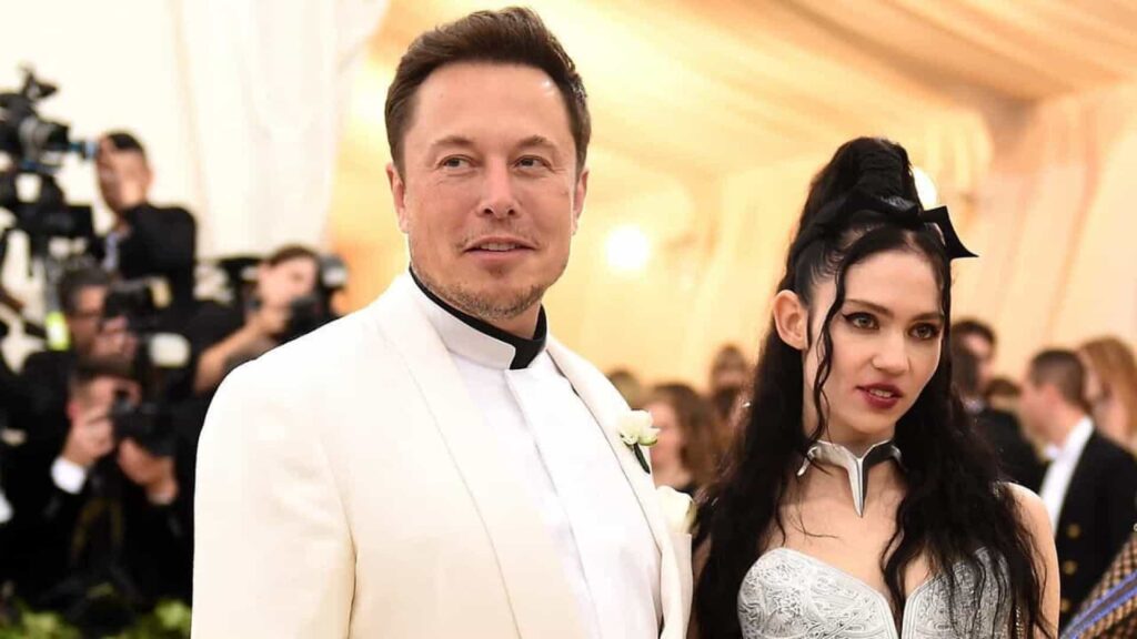 Imagem com foto de Elon Musk em evento ao lado da cantora Grimes