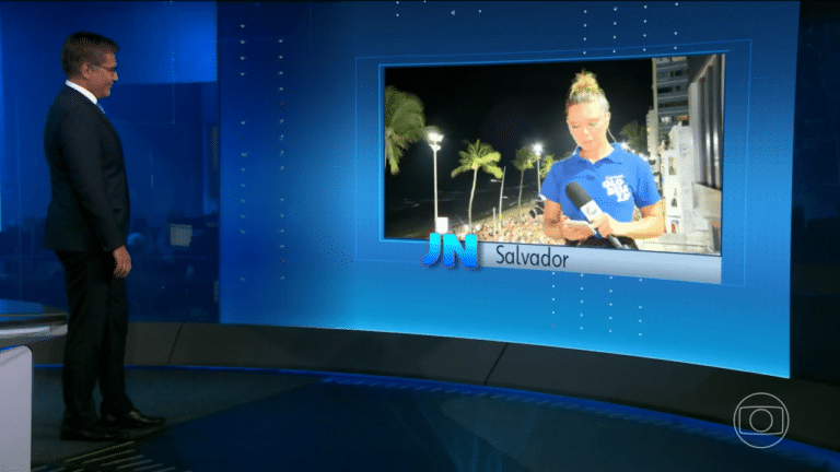 Imagem com foto dos jornalistas Hélter Duarte e Camila Marinho no Jornal Nacional