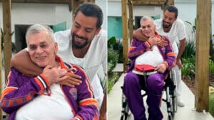 Walcyr Carrasco, autor de Terra e Paixão, em foto na cadeira de rodas sendo abraçado pelo médico Pedro Andrade