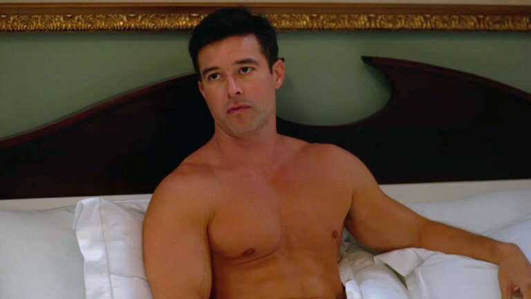 Bernardo Velasco sem camisa como Igor sentado na cama em cena do remake de Vale Tudo