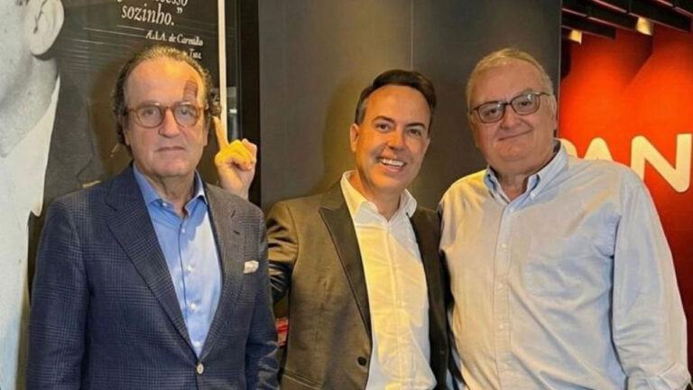 Antonio Augusto Amaral de Carvalho Filho, Rinaldi Faria e Marcelo Carvalho posam juntos sorrindo na sede da emissora Jovem Pan