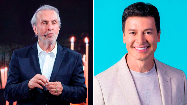 Robério de Ogum fala ao microfone vestindo terno escuro sobre fundo com velas, ao lado de Rodrigo Faro sorrindo de blazer bege em fundo azul claro