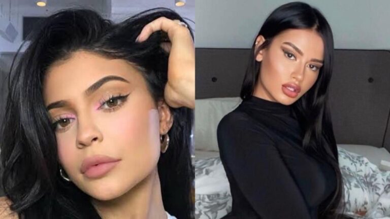 Julia Medeiros sorri com cabelos castanhos longos, veste blusa preta básica, fundo desfocado com folhagens verdes e iluminação natural de dia externo