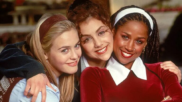 Cher, Dionne e Tai sorrindo abraçadas em cena do filme As Patricinhas de Beverly Hills