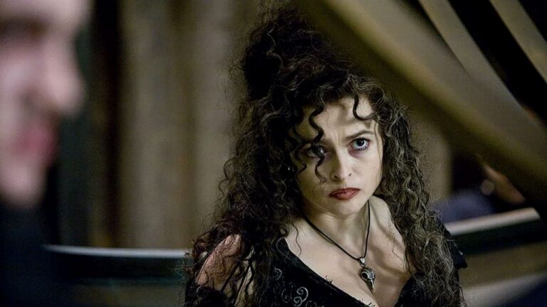 Mulher de cabelo cacheado e expressão intensa encara alguém em cena sombria de filme de fantasia gótica