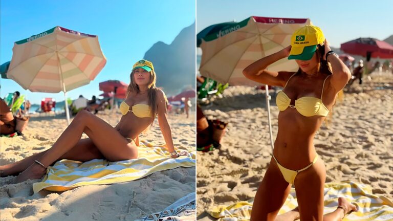 Naty Curvelo posa de biquíni amarelo e boné do Brasil em fotos na praia com guarda-sol e banhistas ao fundo