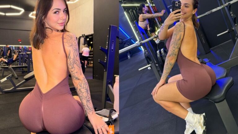Karol Rosalin posa em academia com macacão esportivo marrom durante selfie entre aparelhos de musculação
