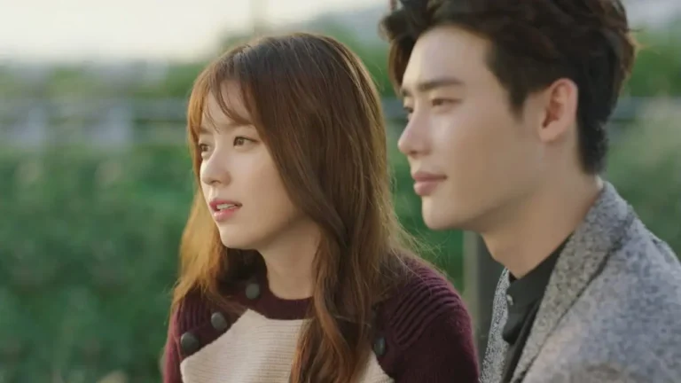 Protagonistas de W Dois Mundos conversam lado a lado ao ar livre em cena do drama sul-coreano W Two Worlds
