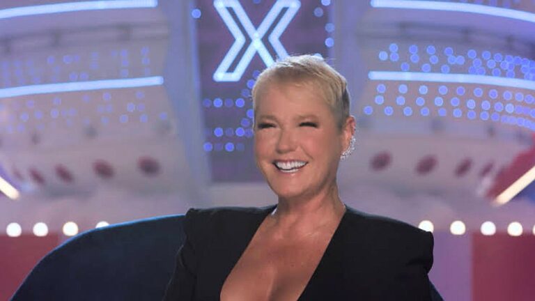 Xuxa sorri no palco durante gravação