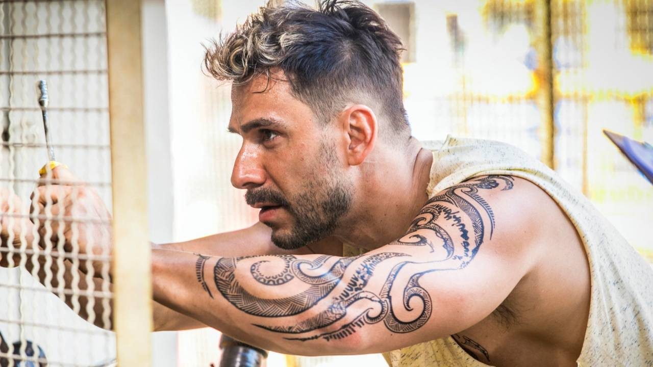 Júlio Rocha caracterizado como Sileno em Ilha de Ferro com tatuagem tribal no braço direito