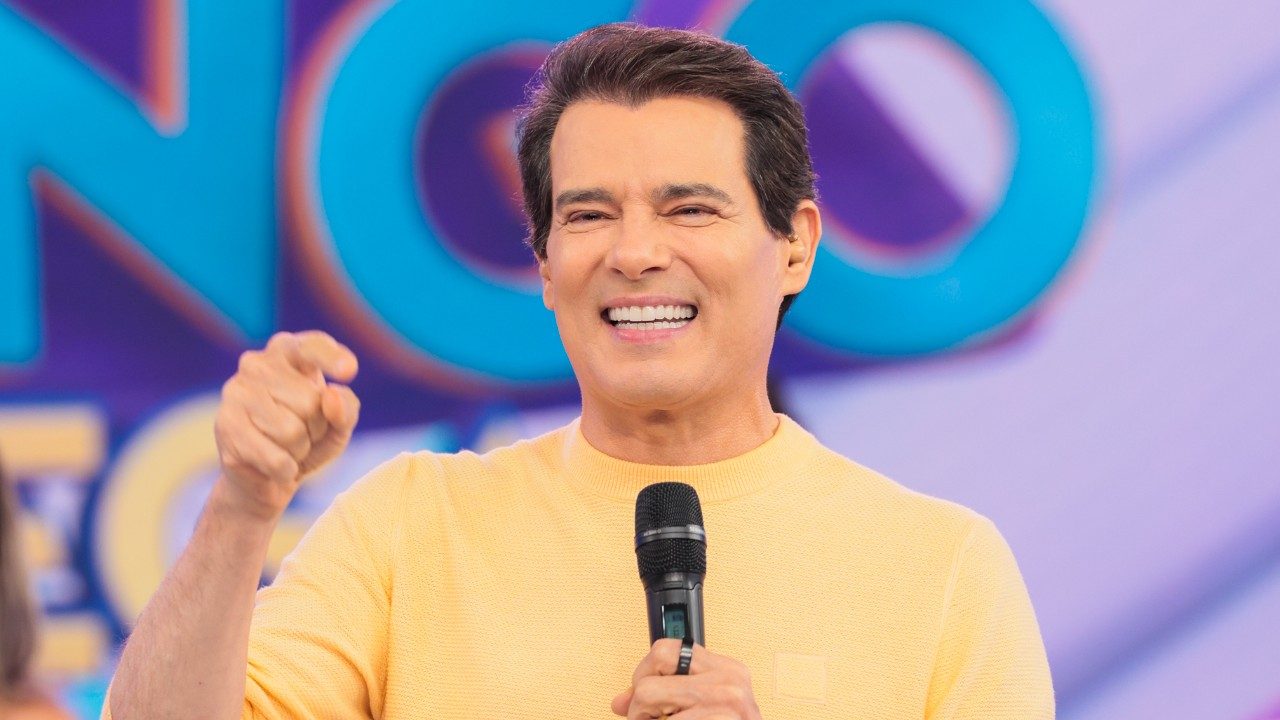 Celso Portiolli sorri e aponta para a plateia durante apresentação do Domingo Legal no SBT