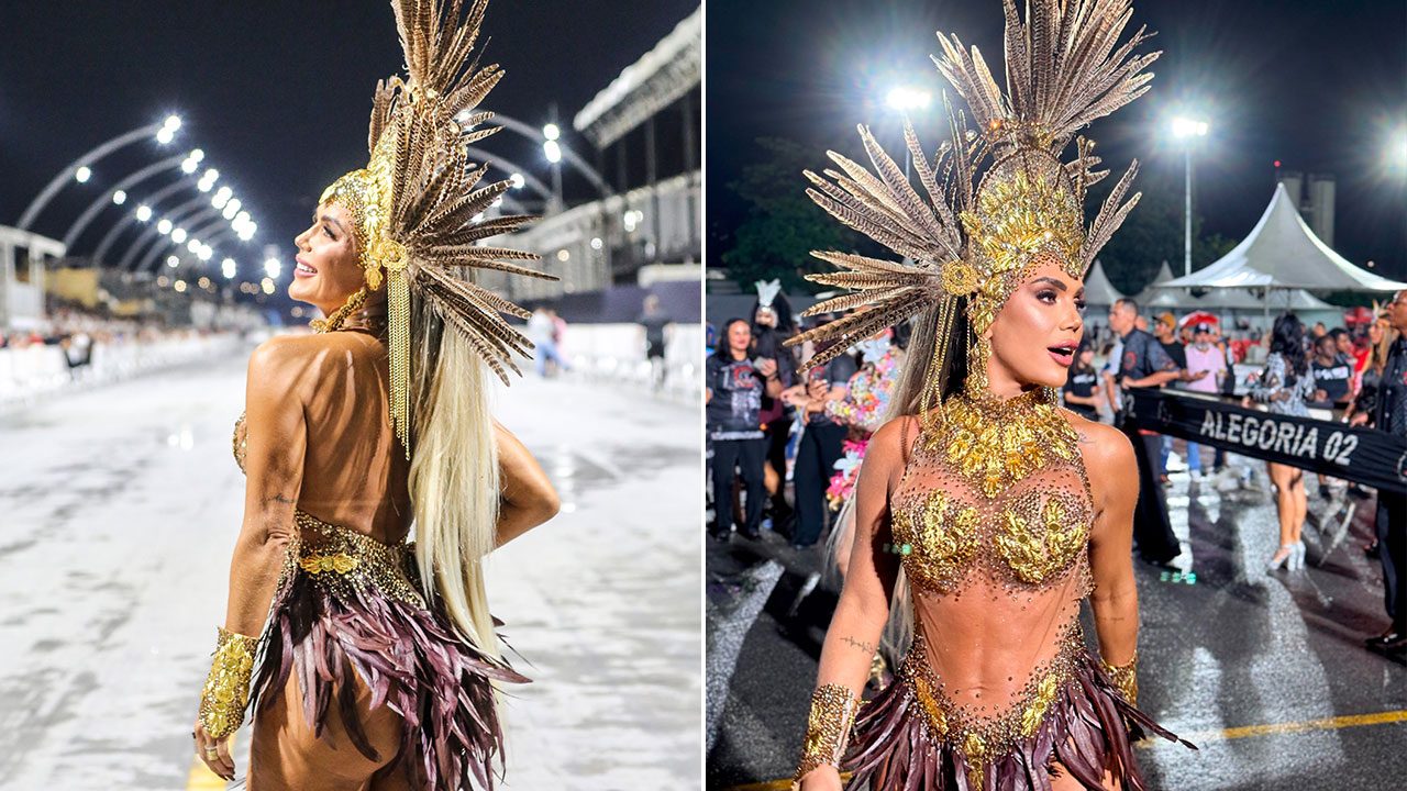 Francine Carvalho desfila com fantasia dourada e cocar de penas no sambódromo à noite durante ensaio de escola de samba