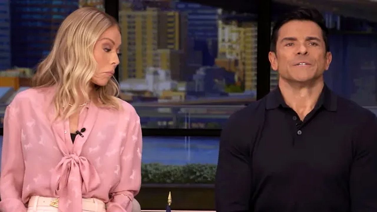 Kelly Ripa reage com expressão irônica enquanto Mark Consuelos fala no estúdio do Live with Kelly and Mark