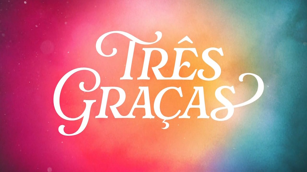 Logotipo da novela Três Graças com letras brancas em fundo colorido em tons de rosa, laranja e azul