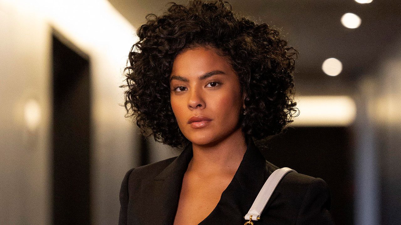 Bella Campos caracterizada como Maria de Fátima com expressão séria em cena da novela Vale Tudo