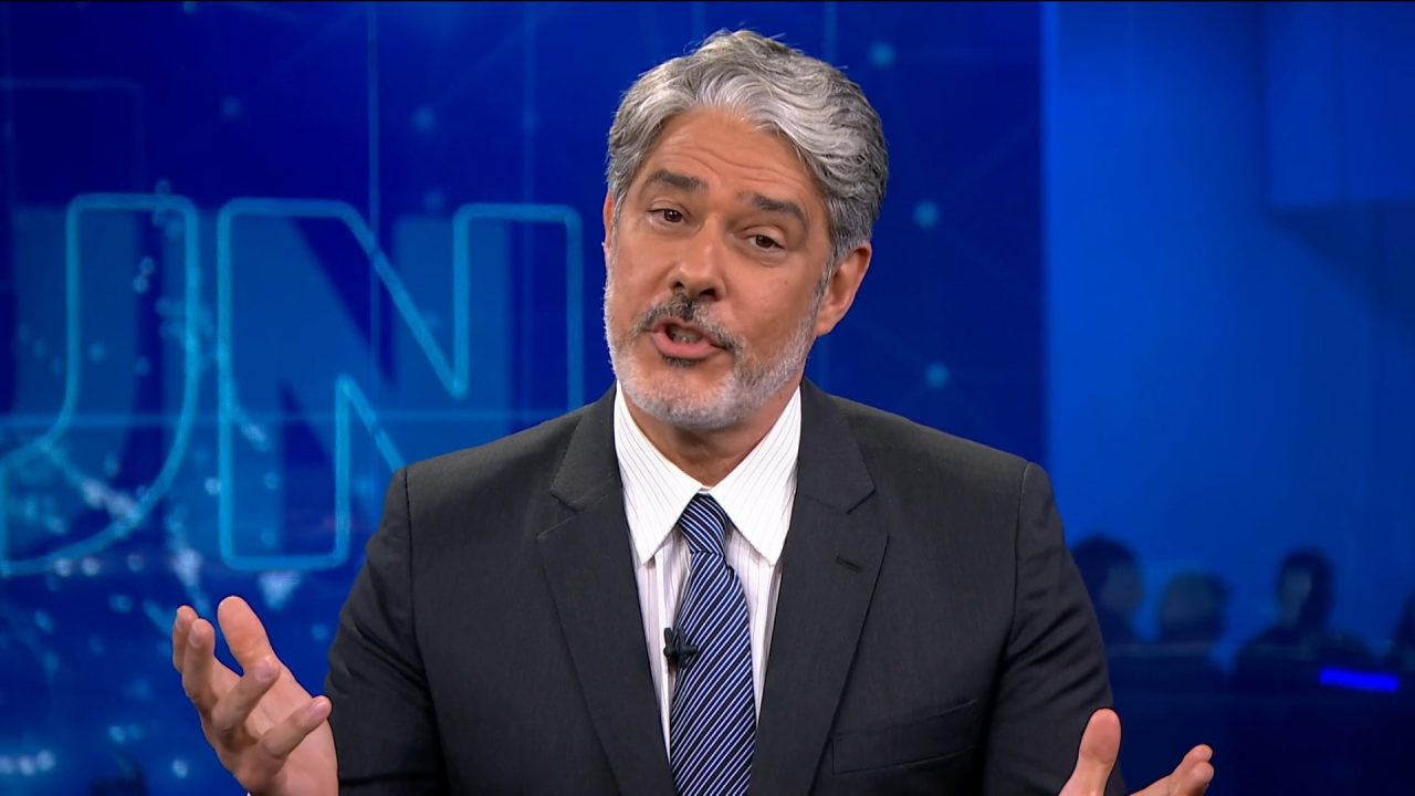 Foto do apresentador William Bonner, vestindo um terno preto com gravata azul, em sua última edição do Jornal Nacional