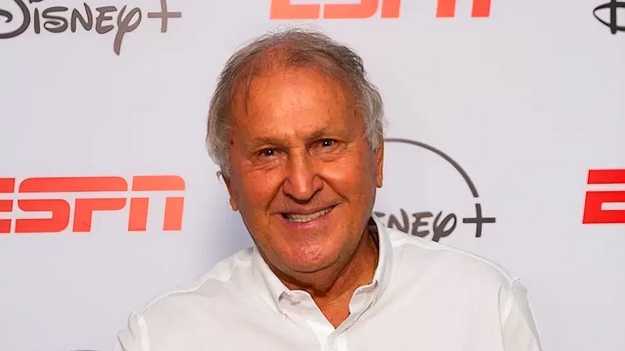 Zico sorri e aponta para logotipo da ESPN em painel de evento com marcas Disney+ e ESPN ao fundo